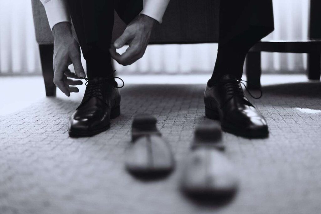 uomo mette scarpe